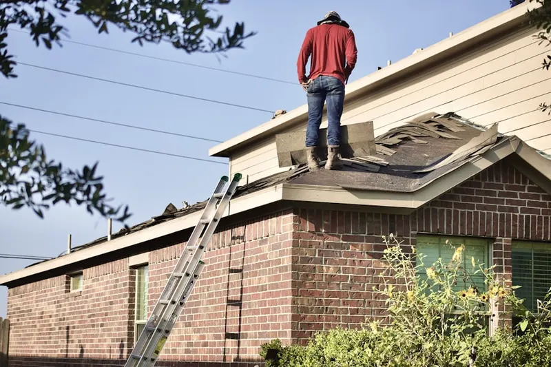 Professional roofer working on a residential roof in Browns